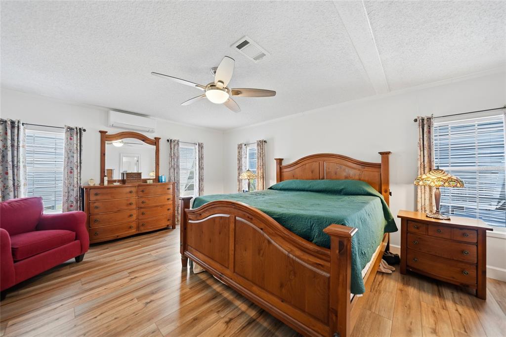 10303 Burnt Store Road, Unit 143 Punta Gorda, FL 33950 - Photo 12 of 42 a bedroom with furniture and wooden floor