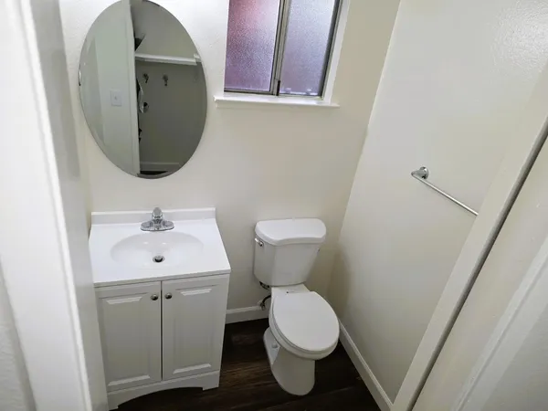a bathroom with a toilet sink and mirror