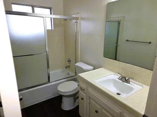 a bathroom with a sink toilet and shower