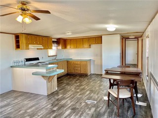 360 County Road 462 Elgin, TX 78621 - Photo 5 of 13 a kitchen with granite countertop a stove a sink and a refrigerator