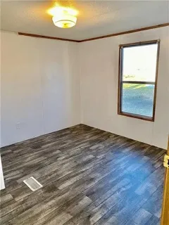 an empty room with a wooden floor and a window