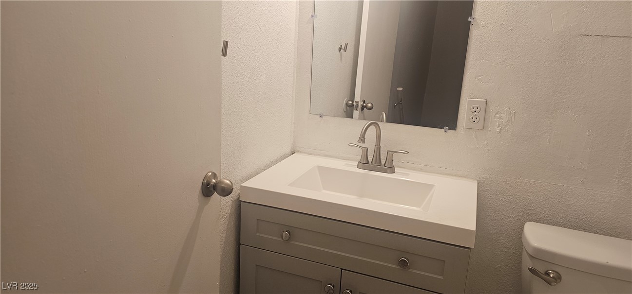 1344 Lorilyn Avenue, Unit 2 Las Vegas, NV 89119 - Photo 9 of 15 Bathroom with a textured wall and vanity