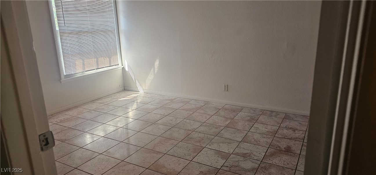 1344 Lorilyn Avenue, Unit 2 Las Vegas, NV 89119 - Photo 10 of 15 Unfurnished room with light tile patterned flooring and baseboards