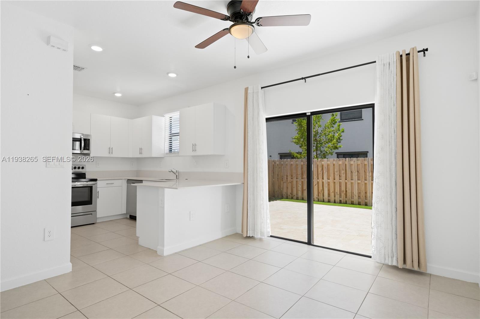 13388 Southwest 286th Street Homestead, FL 33033 - Photo 11 of 46 a kitchen with white cabinets and white appliances