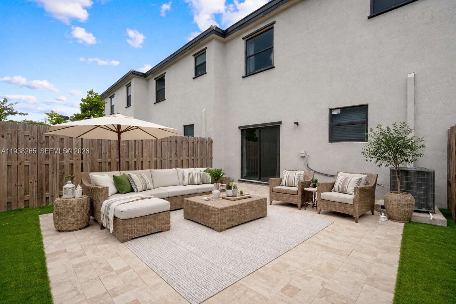 13388 Southwest 286th Street Homestead, FL 33033 - Photo 2 of 46 a patio with patio a couch and a fireplace