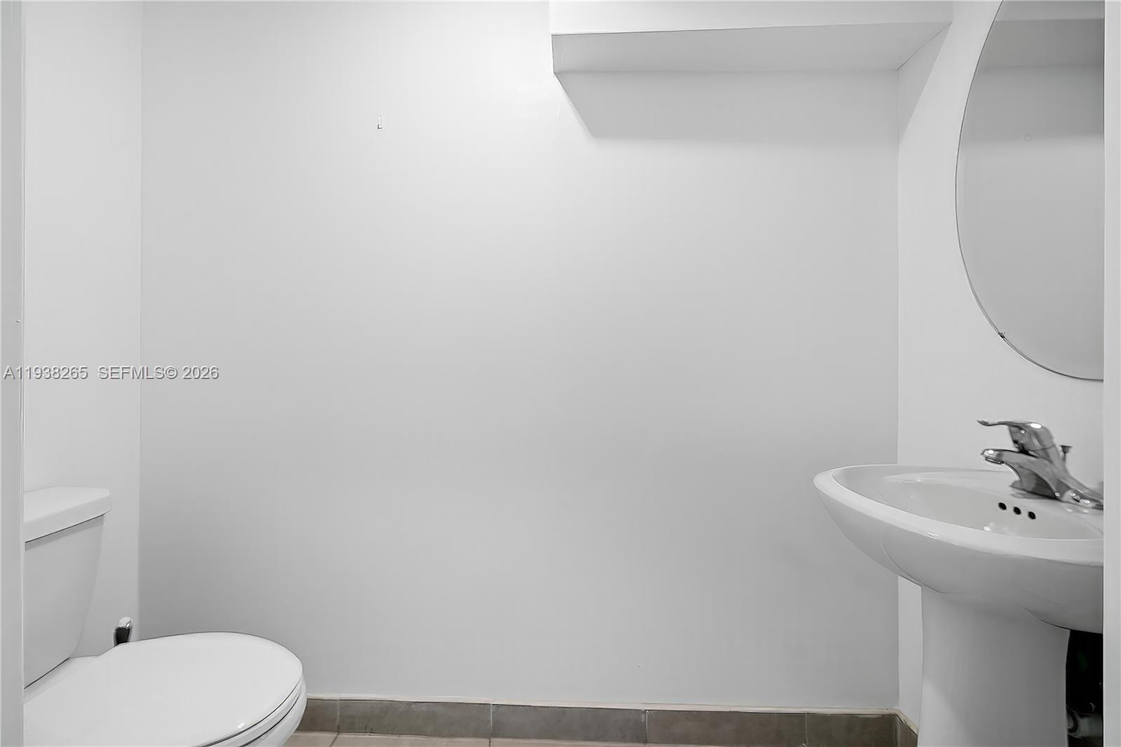 13388 Southwest 286th Street Homestead, FL 33033 - Photo 36 of 46 a bathroom with a sink a toilet and mirror