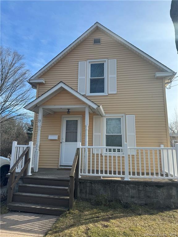 a view of a house with a small yard and a large window