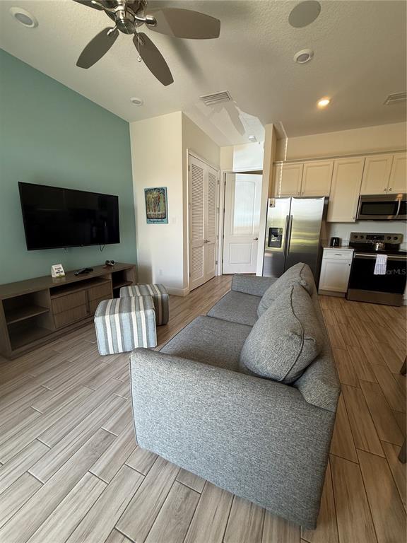 2986 Salted Rim Road Kissimmee, FL 34747 - Photo 11 of 32 a living room with furniture and a flat screen tv