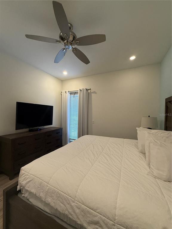 2986 Salted Rim Road Kissimmee, FL 34747 - Photo 14 of 32 a bedroom with a bed and a flat screen tv