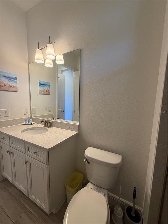 2986 Salted Rim Road Kissimmee, FL 34747 - Photo 17 of 32 a bathroom with a toilet sink and mirror