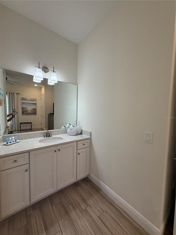 2986 Salted Rim Road Kissimmee, FL 34747 - Photo 24 of 32 a bathroom with a double vanity sink and a mirror