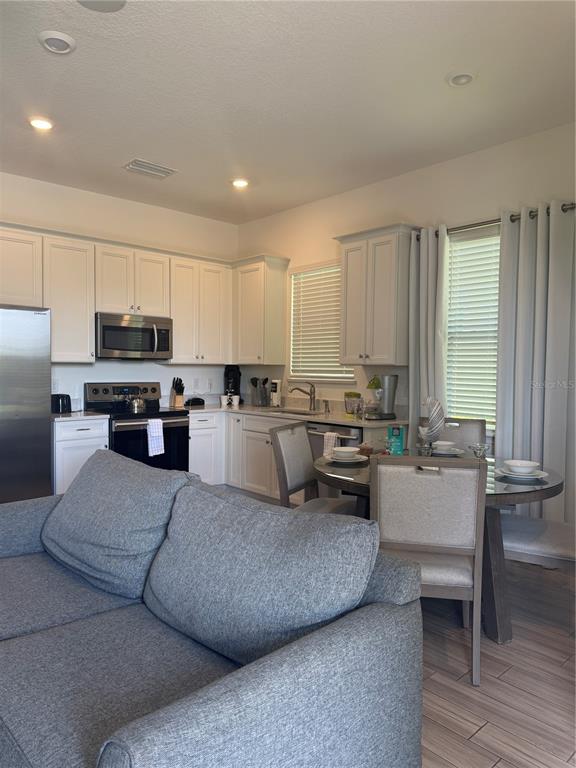 2986 Salted Rim Road Kissimmee, FL 34747 - Photo 3 of 32 a living room with furniture and kitchen view
