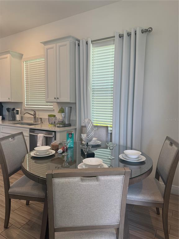 2986 Salted Rim Road Kissimmee, FL 34747 - Photo 4 of 32 a kitchen with a dining table chairs and white cabinets