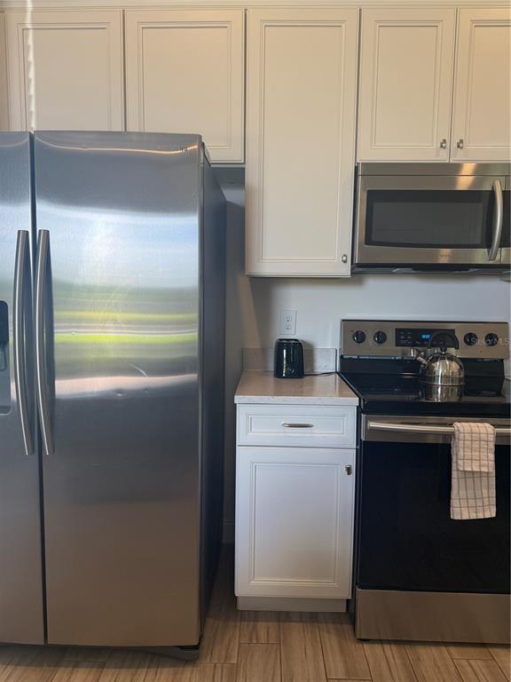 2986 Salted Rim Road Kissimmee, FL 34747 - Photo 7 of 32 a kitchen with a refrigerator stove and microwave