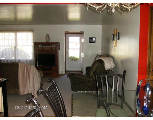 Living Room. *View from Dining Room Table Looking into Living Room and Entry Way*