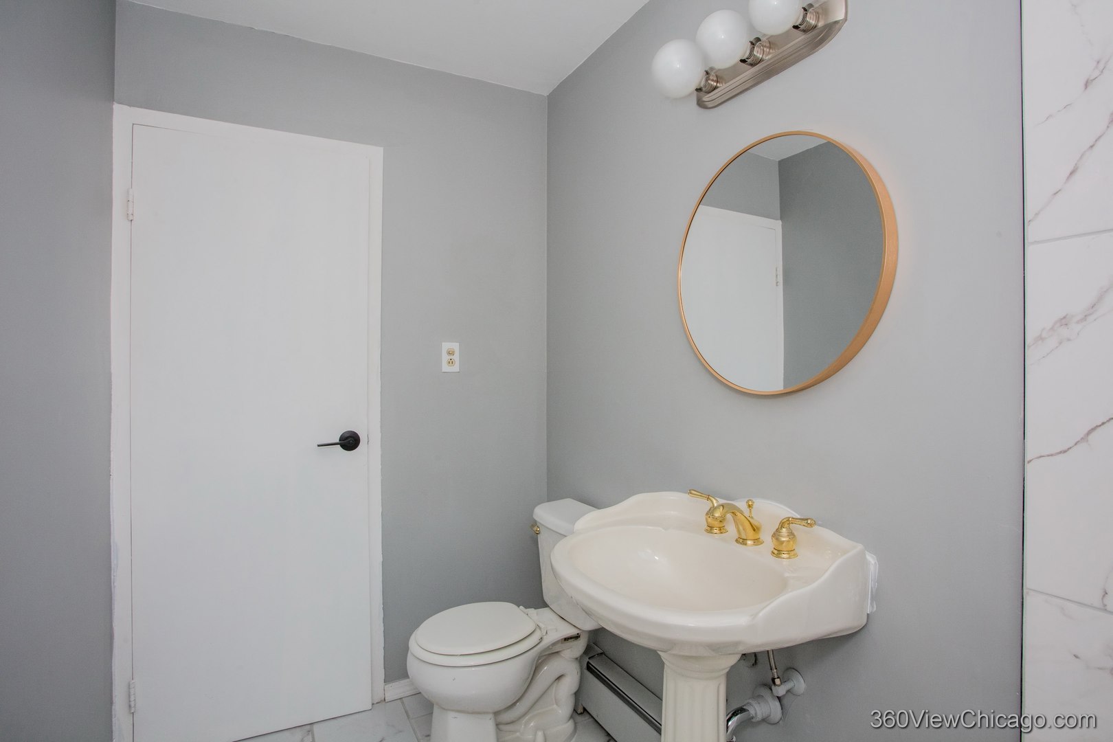 6300 North Sheridan Road, Unit 517 Chicago, IL 60660 - Photo 5 of 13 a bathroom with a toilet sink and mirror
