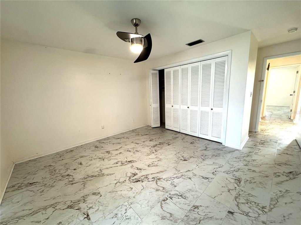 610 Indian Rocks Road North, Unit 103 Belleair Bluffs, FL 33770 - Photo 9 of 13 a view of a livingroom with wooden floor and windows