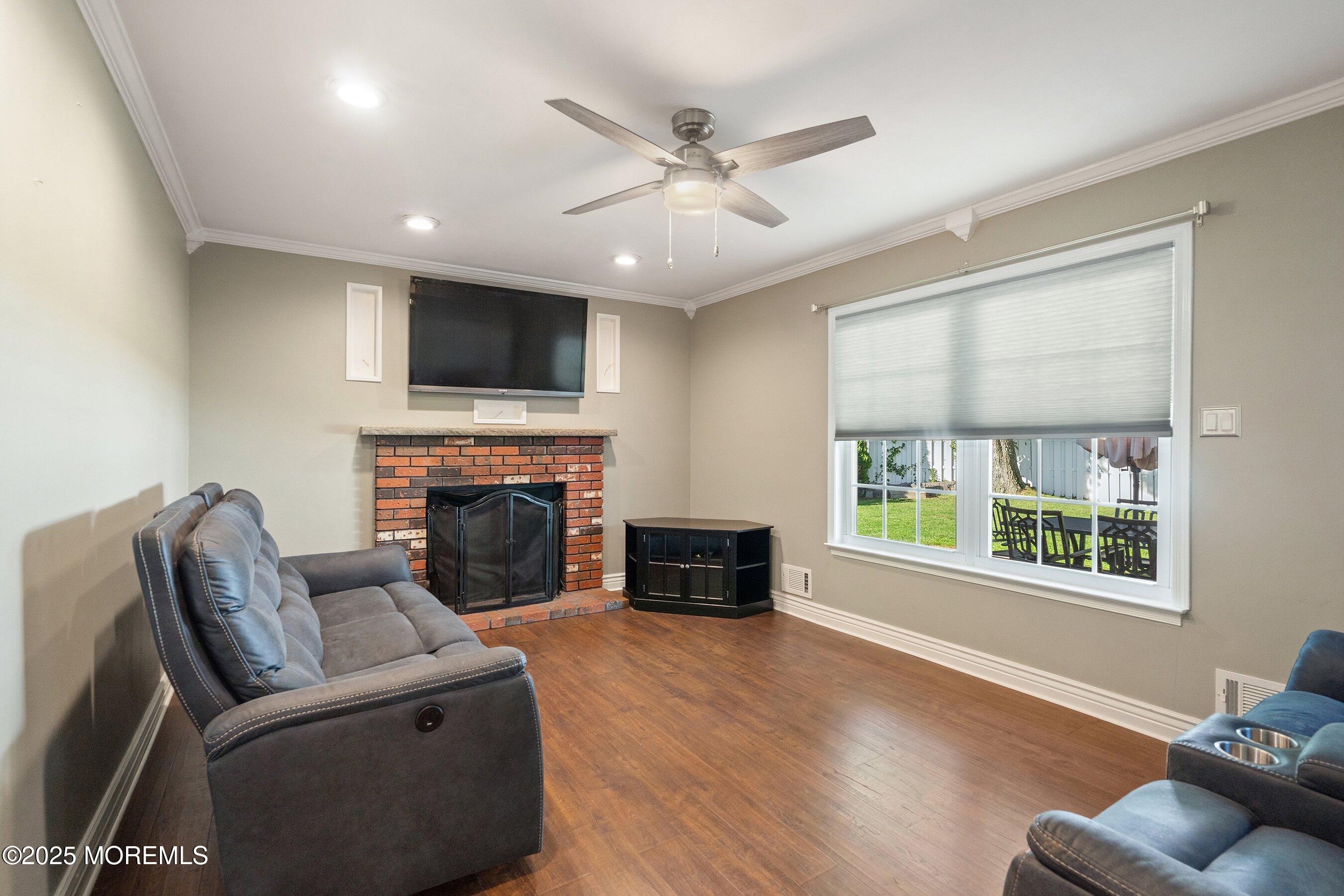 131 Starlight Road Howell, NJ 07731 - Photo 15 of 35 a living room with furniture a fireplace and a flat screen tv