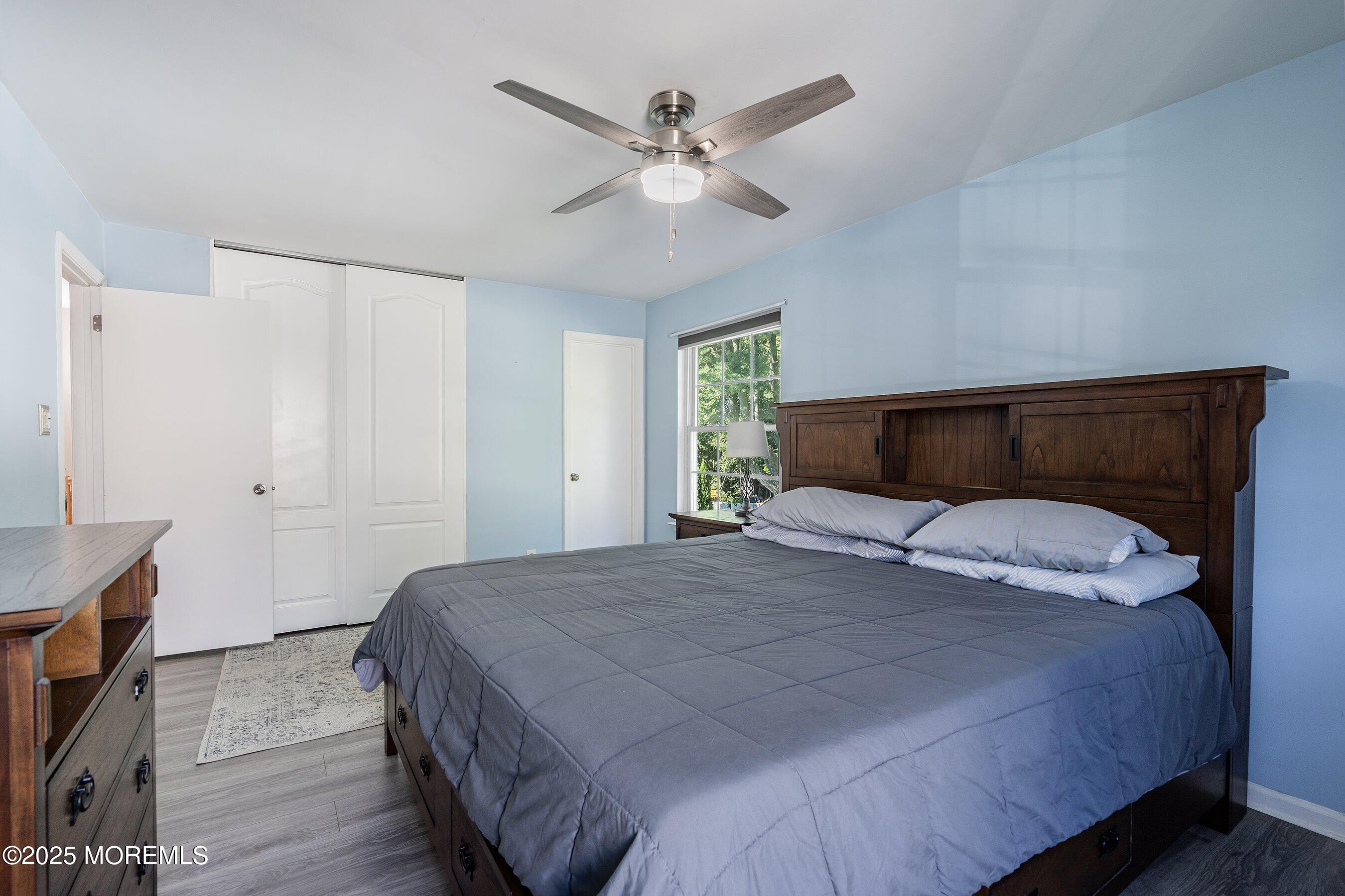 131 Starlight Road Howell, NJ 07731 - Photo 20 of 35 a bedroom with a bed and a chandelier