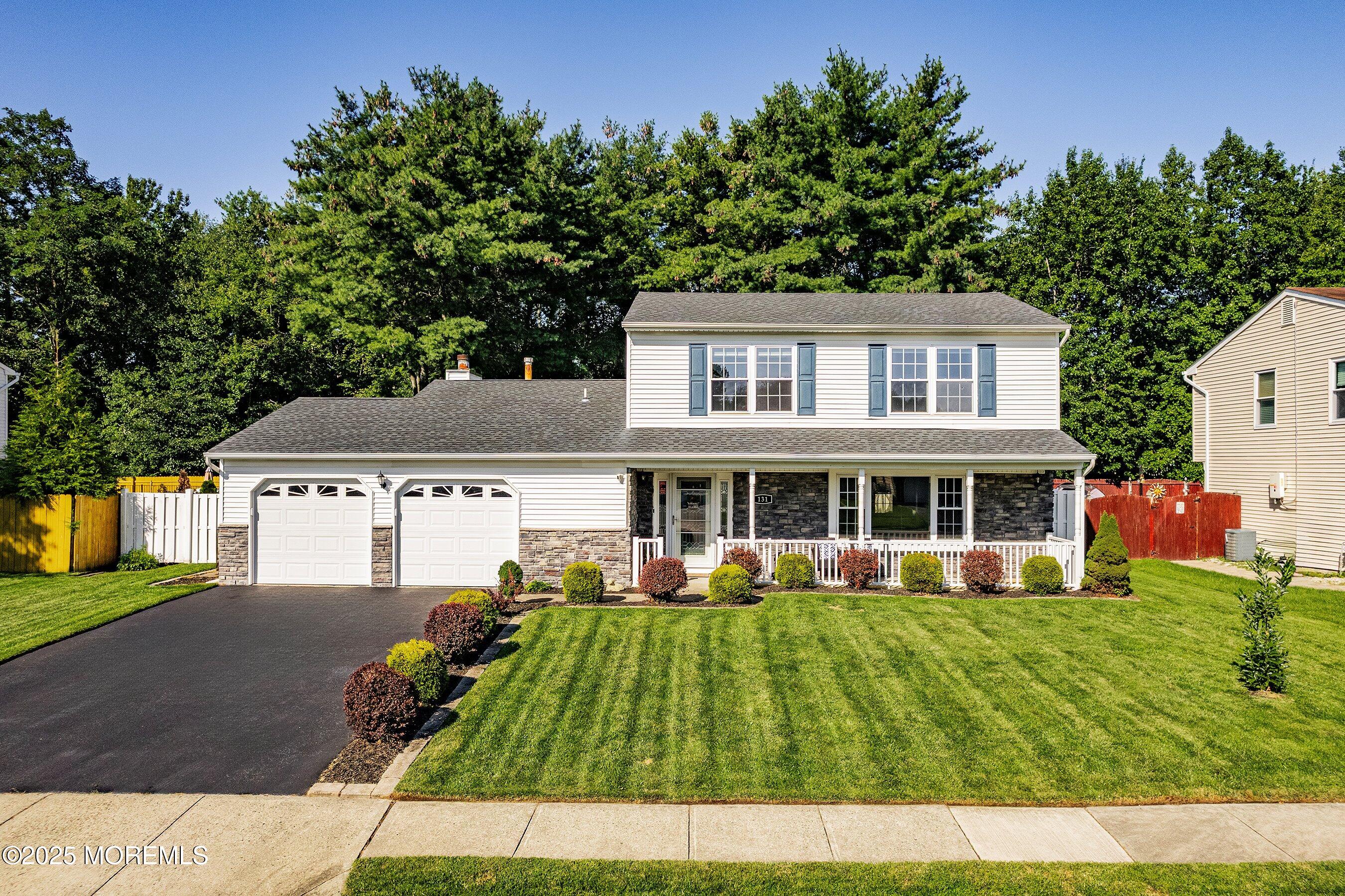 131 Starlight Road Howell, NJ 07731 - Photo 2 of 35 a front view of a house with a garden