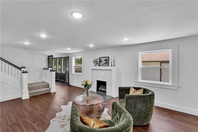 a living room with fireplace furniture and a wooden floor