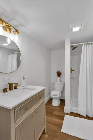 a bathroom with a sink toilet and a mirror