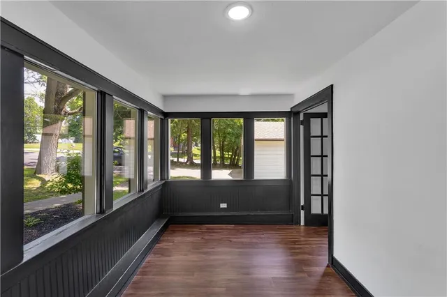 a view of room with wooden floor and walls