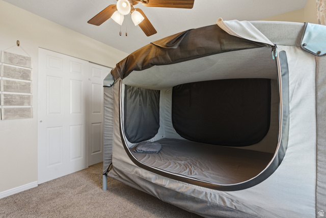 11189 Ohenry Road East Sandy, UT 84070 - Photo 21 of 44 Carpeted bedroom featuring a ceiling fan with light fixture and bifold closet doors