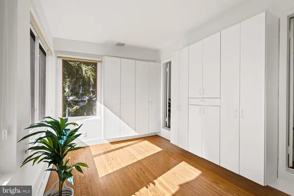 a view of a room with a window and wooden floor