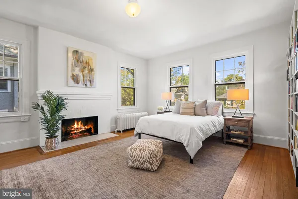 a spacious bedroom with a bed and a fireplace