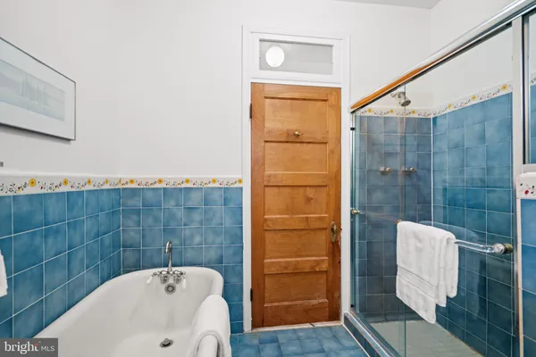 a bathroom with a bathtub and shower