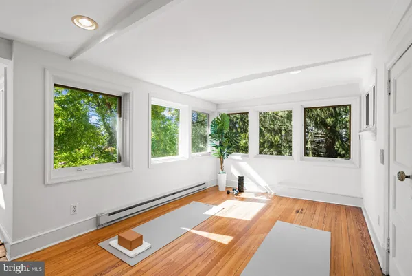 a view of a room with wooden floor and pool table