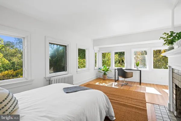 a bedroom with a large window and a table