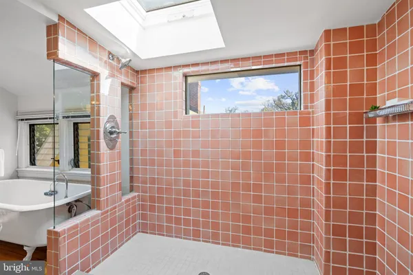 a bathroom with a bathtub and a shower