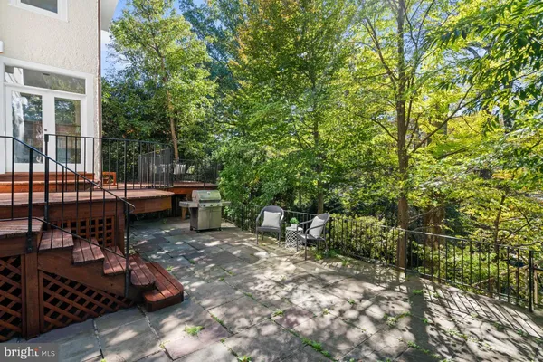 a view of a patio with chairs and potted plants