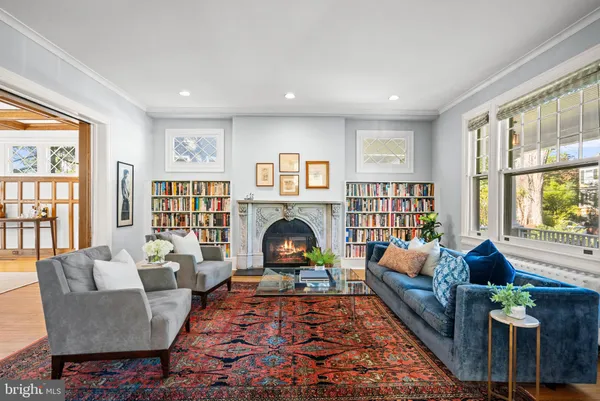 a living room with furniture fireplace and window