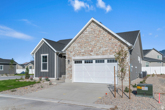 5644 Ibis Road Tooele, UT 84074 - Photo 3 of 19 Modern exterior featuring stacked stone and vertical siding accents