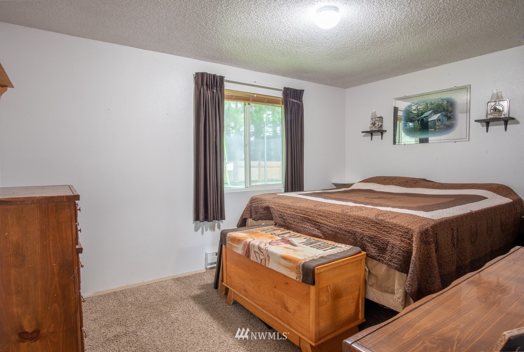 4620 Crescent Court Southwest Rochester, WA 98579 - Photo 11 of 12 a bedroom with a bed and a window