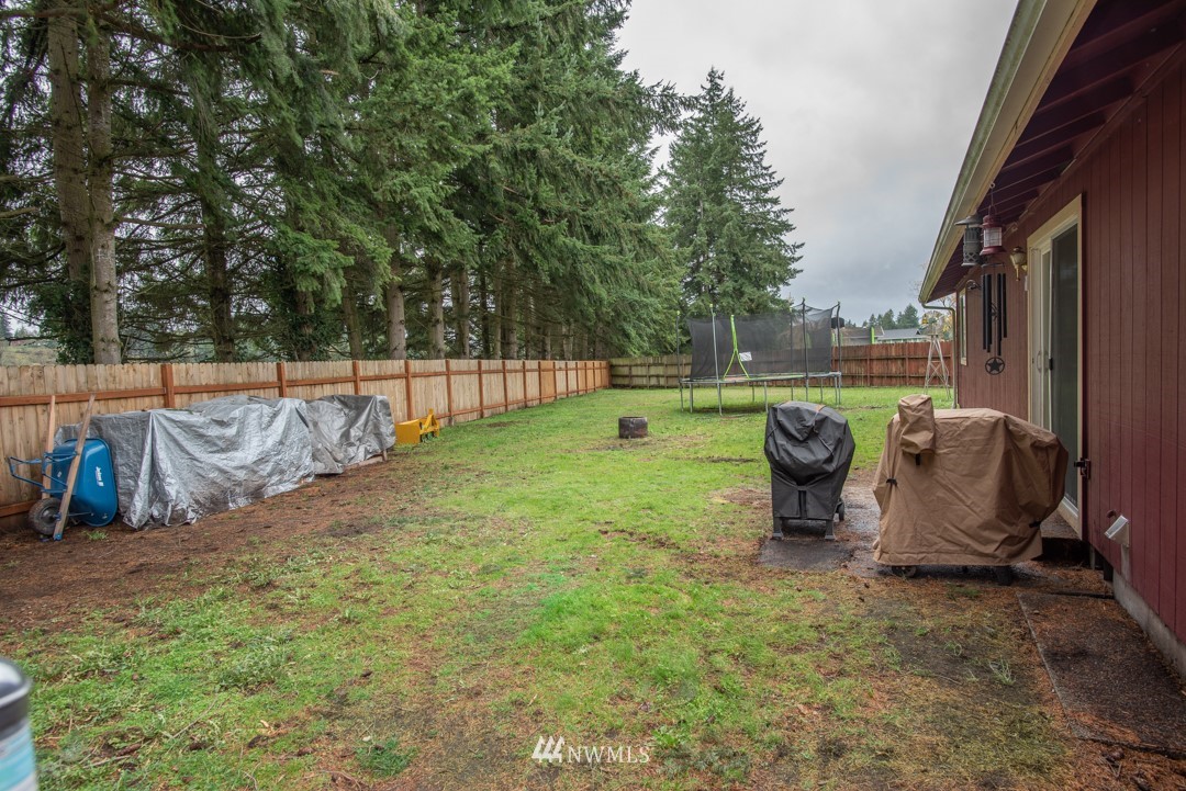 4620 Crescent Court Southwest Rochester, WA 98579 - Photo 12 of 12 a view of a backyard with table and chairs