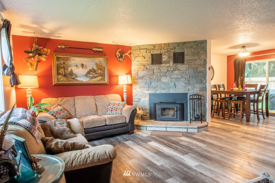4620 Crescent Court Southwest Rochester, WA 98579 - Photo 3 of 12 a living room with furniture and a fireplace