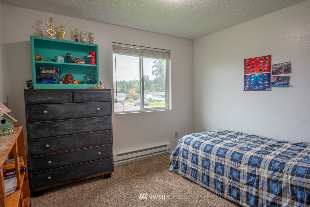4620 Crescent Court Southwest Rochester, WA 98579 - Photo 5 of 12 a bedroom with a bed and a window