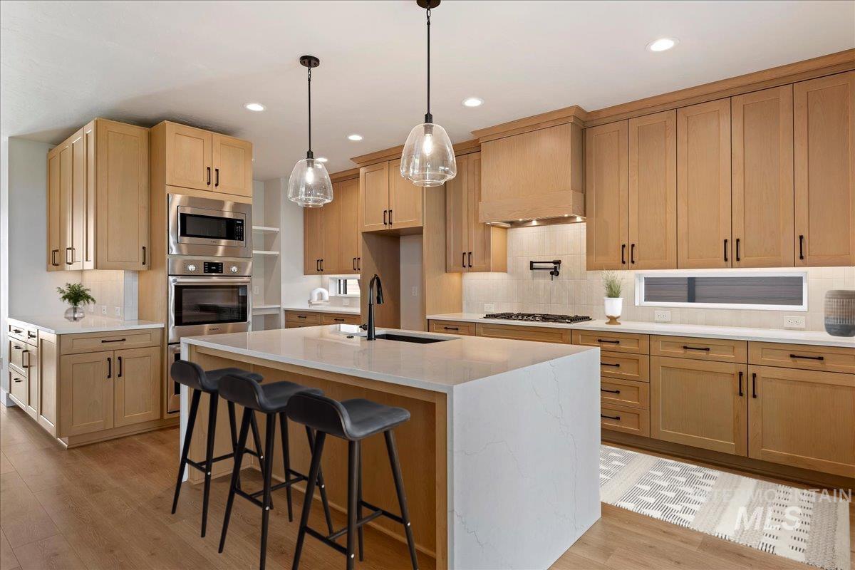 8410 West Graye Street, Unit ALPINE Meridian, ID 83646 - Photo 41 of 45 Spacious upper-level landing featuring plush gray carpeting, a contemporary chandelier, and a black and wood-finish horizontal railing