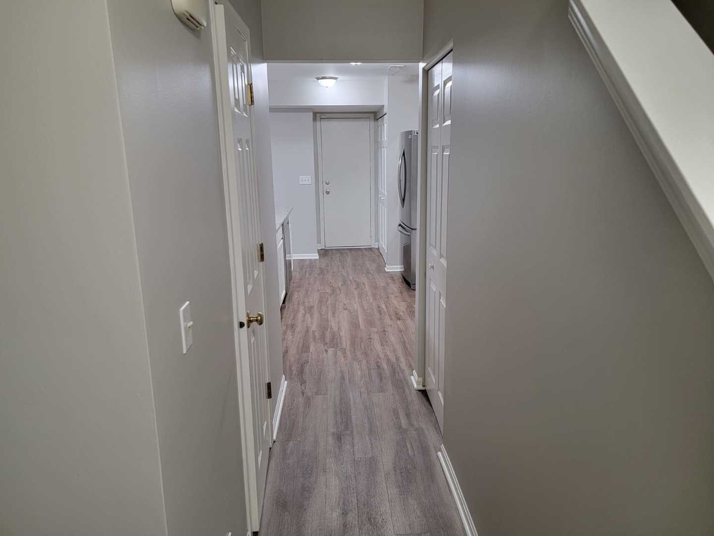 889 Symphony Drive Aurora, IL 60504 - Photo 12 of 24 a view of a hallway with wooden floor