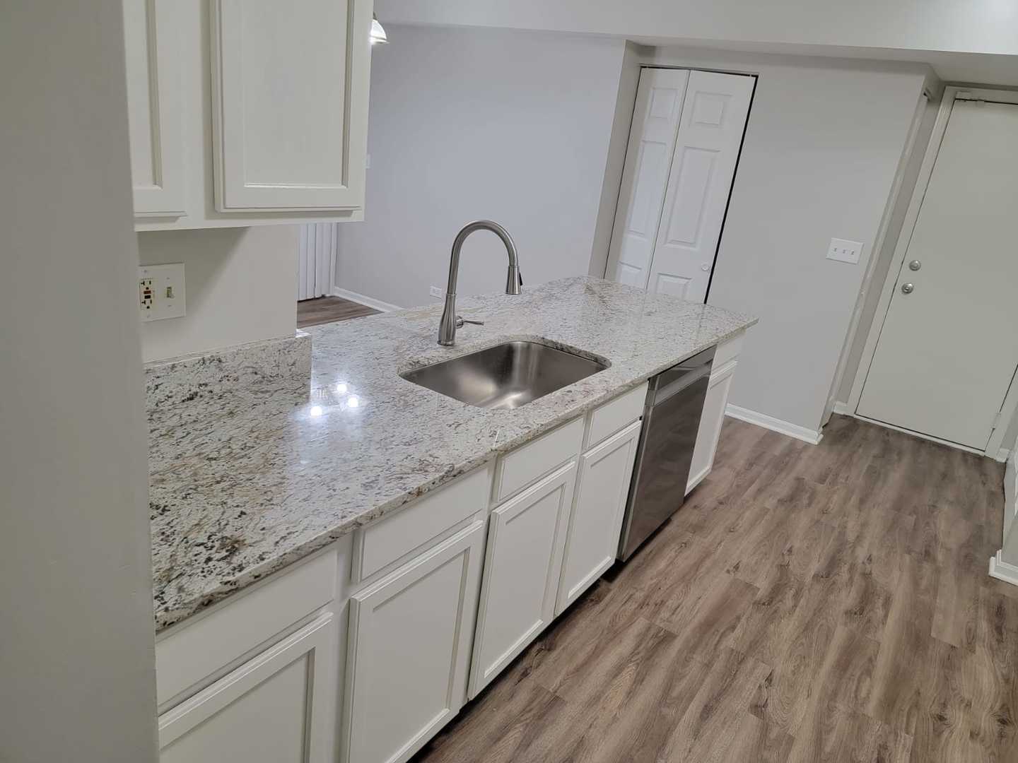 889 Symphony Drive Aurora, IL 60504 - Photo 24 of 24 a kitchen with stainless steel appliances granite countertop a sink a stove and cabinets with wooden floor