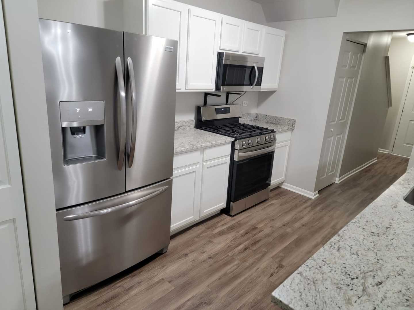 889 Symphony Drive Aurora, IL 60504 - Photo 6 of 24 a kitchen with stainless steel appliances a refrigerator a microwave a sink and a refrigerator