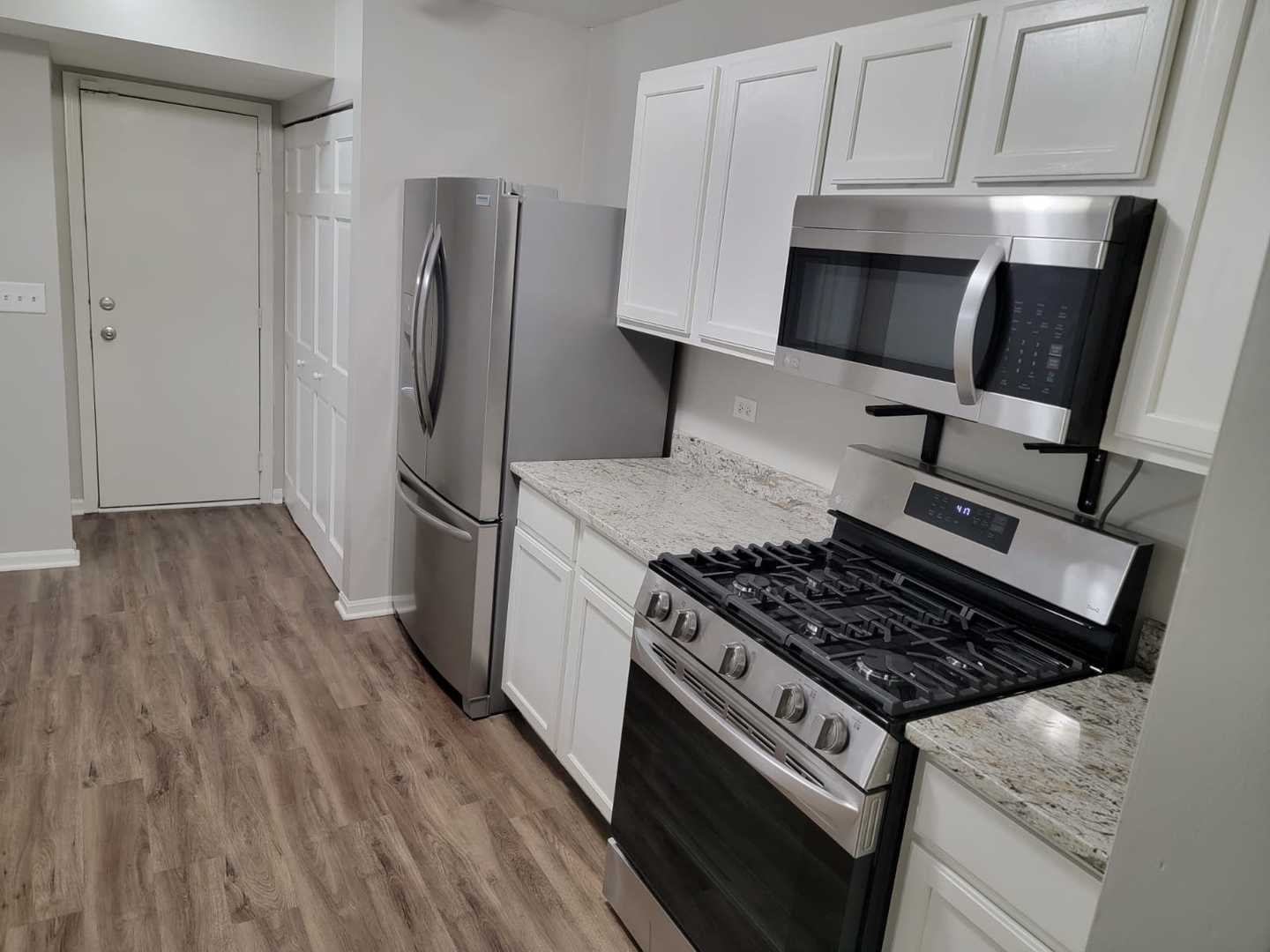 889 Symphony Drive Aurora, IL 60504 - Photo 9 of 24 a kitchen with granite countertop a stove and a refrigerator