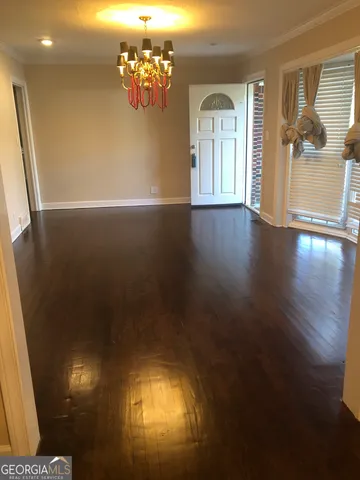 a view of a livingroom with wooden floor and a window