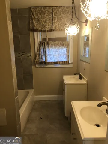 a bathroom with a sink a toilet and bathtub