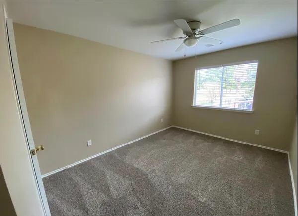 a view of an empty room and a window