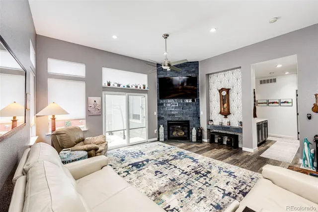 a living room with furniture a fireplace and a flat screen tv